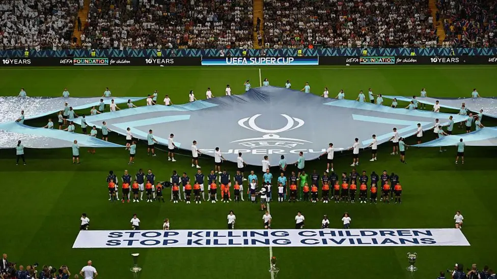 Uefa displays ‘stop killing children’ banner